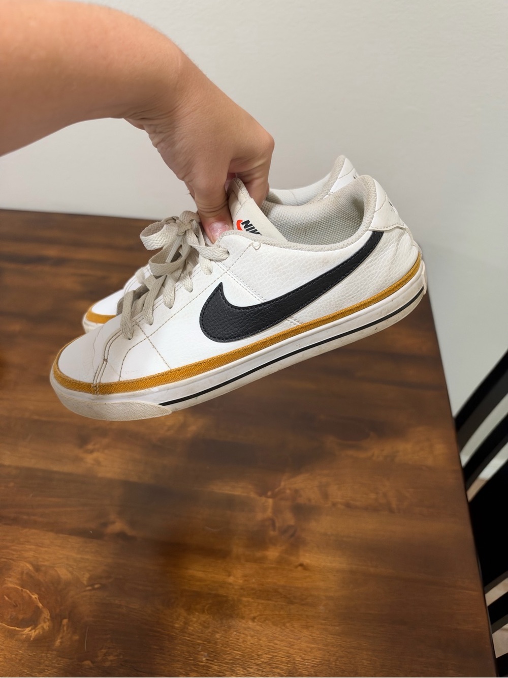 Nike Men’s White Sneakers with Black Swoosh and Gold Accent